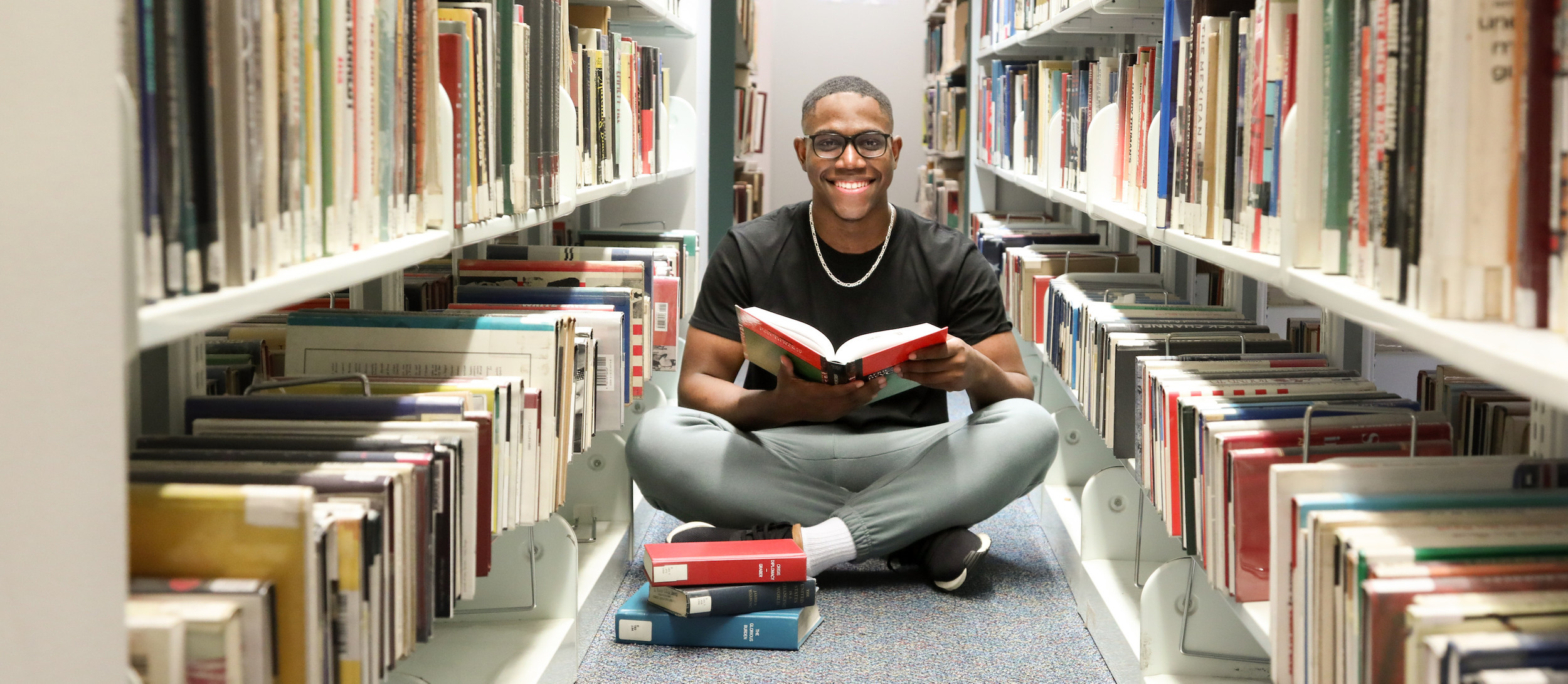 Young man in bookstore or library