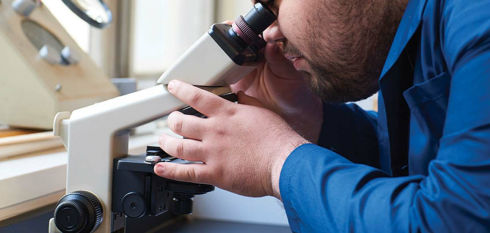 Student Looking Into Microscope